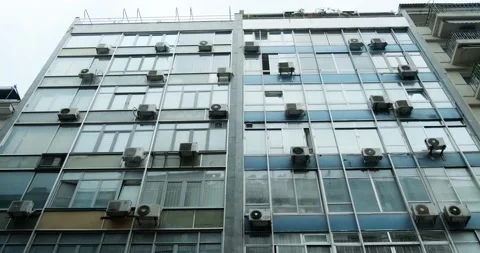 Low angle view of urban building facade with many air conditioners. Video stock 154265692