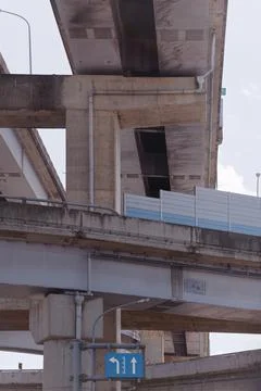 Low Angle View of Urban Freeway Interchange with Blue Direction Sign 写真素材