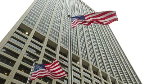 Low angle view of the US flags and a skyscraper in the background Stock Footage 154252875