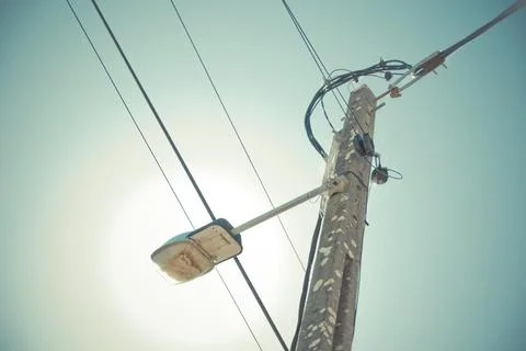 Low angle view of utility pole with electrical wires and a streetlight agai.. Foto stock