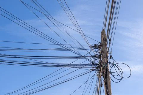 Low angle view of a utility pole with numerous power and communication line.. Stock Photos