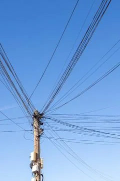 Low angle view of a utility pole with numerous power and communication line.. Stock Photos