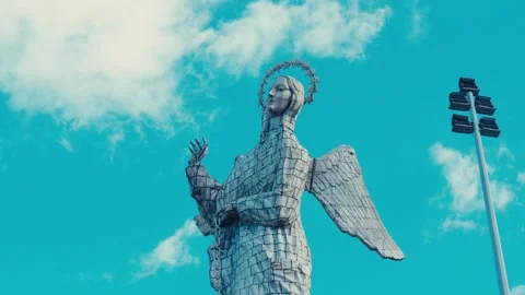 Low-angle view of the Virgin of El Panecillo statue in Quito, Ecuador, against Stock Footage 345092059