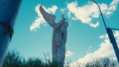 Low-angle view of the Virgin of El Panecillo statue in Quito, Ecuador, against Stock Footage 345092174