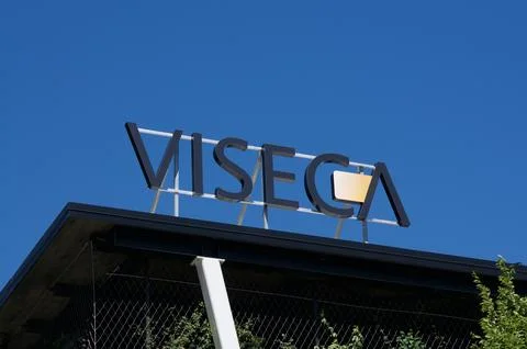 Low angle view of the Viseca corporate sign on a building roof in Switzerland Stock Photos