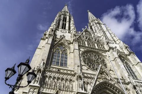 Low-angle view of Votivkirche under a bright blue sky Stock Photos