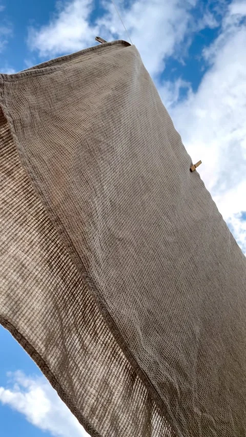 Low-angle view of a waffle towel swaying in the wind Stock Footage 344301672