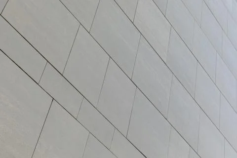 Low angle view of wall with gray smooth tiles of different shape (rectangular Stock Photos