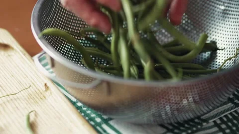 Low angle view of washing organic green beans in a metal colander Stock Footage 343555657
