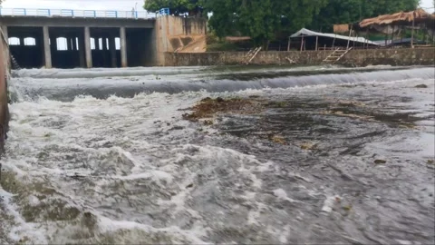 Low Angle View of Water Flowing from Sluice Gate Dam Stock Footage 343774871