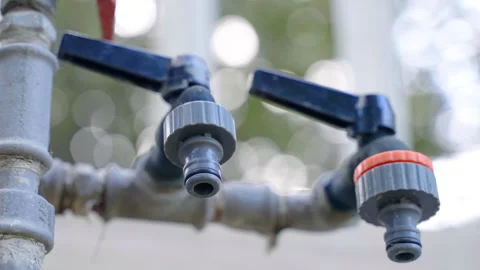 Low angle view of water hose faucets for household usage or irrigation system Stock Footage 260295040