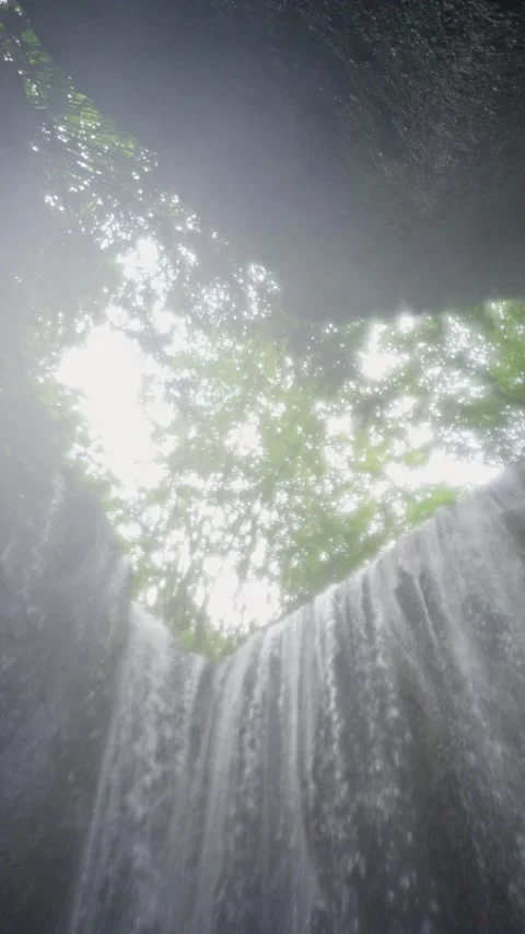 Low angle view of waterfall grotto with sunbeam Stock Footage 341515893