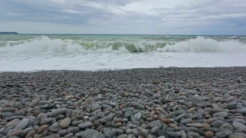 Low angle view of waves breaking along Looc Pebble Beach in Surigao Stock Footage 313526231