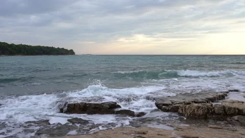 A low-angle view of the wavy sea at sunset Stock Footage 285964737