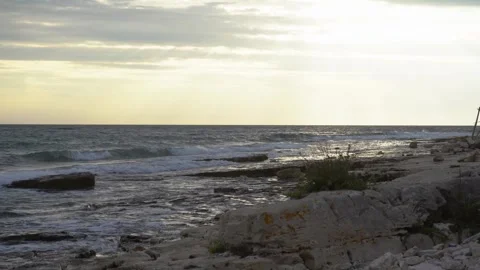 A low-angle view of the wavy sea at sunset Stock Footage 285964808