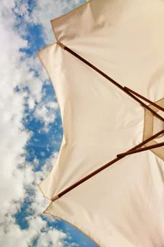 Low angle view of white beach umbrella Fotos de archivo