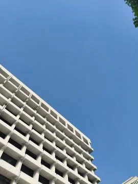 Low-angle view of a white building against a clear blue sky Stock Photos
