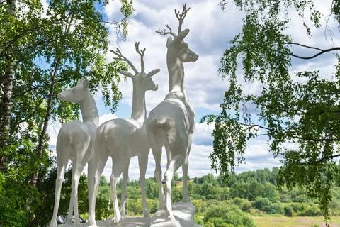Low angle view of white deer sculpture and antlers against the sky in Ukhta Stock Photos