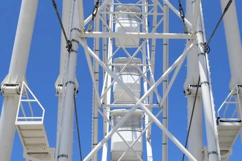 Low-angle view of a white Ferris wheel structure Stock Photos