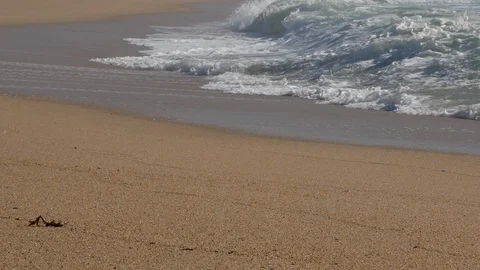 Low angle view of white foamy waves crashing on sandy beach in Portugal Stock Footage 103637885