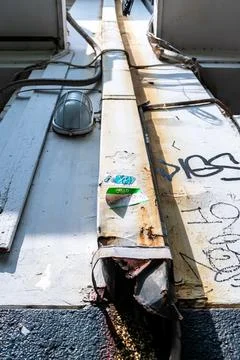Low angle view of white rustic iron square water pipe on the white wall with  Stock Photos