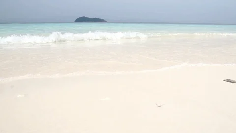 Low angle view of white sand beach and blue chrystal clear sea water wa Stock Footage 87897349