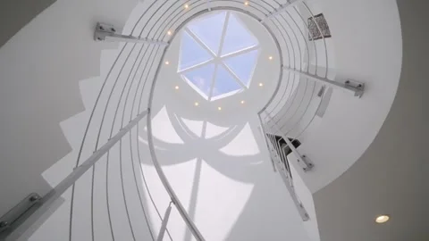 Low angle view of white spiral stairs inside luxury mansion with creative Stock Footage 245652883