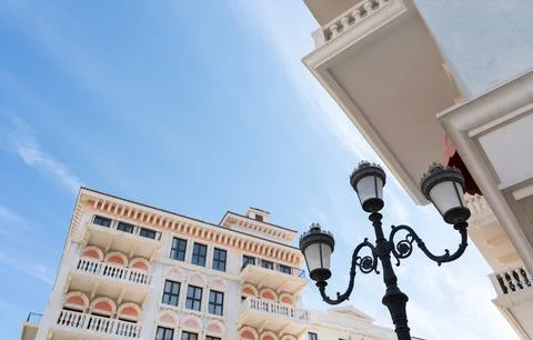 Low Angle View of White Venetian Style Buildings and Ornate Street Lamp Stock Photos
