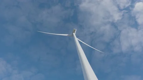 Low angle view of wind turbine against a blue sky. Renewable energy concept. Stock Footage 148426896