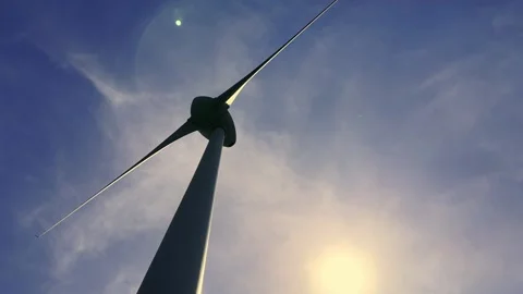 Low Angle View on a Wind turbine Against the Sky with the Sun Stock Footage 282701421