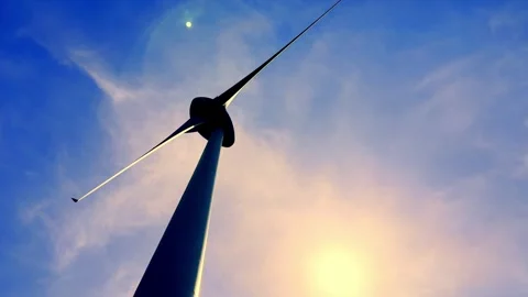 Low Angle View on a Wind turbine Against the Sky with Clouds and the Sun Stock Footage 284114780