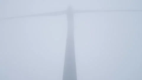 Low Angle View of Wind Turbine in Thick White Fog and Mist Stock-Footage 332712139