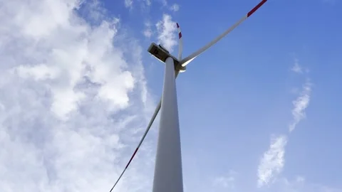 Low Angle View of Wind Turbine Against Blue Sky and Clouds Vídeo Stock 335215322