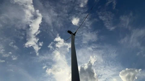 Low Angle View of Wind Turbine Blades Against Dramatic Cloudy Sky Stock Footage 335809091
