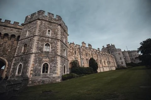 A low-angle view of Windsor Castle's exterior wall, showcasing the grey stone, Stock Photos