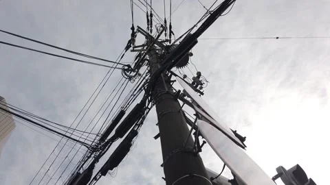 Low Angle View of Wires, Cables, and Electricity Pole Over Skyline in Kyoto Stock Footage 342296675