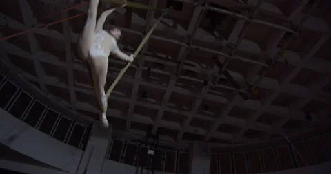 Low angle view on a woman doing a split in the air, aerial silks, athletic, 4k Stock Footage 147486284