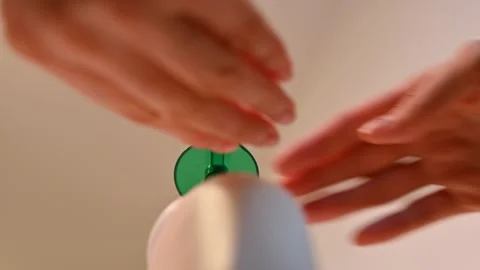 Low angle view of woman using liquid soap dispenser Stock Footage 147221427