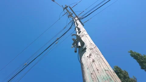 Low angle view of wooden utility pole and electrical power lines Stock Footage 340118328
