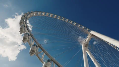 Low angle view of world's biggest Ferris wheel slowly spinning Video stock 304316870