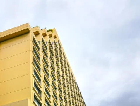 Low Angle View of Yellow Building with Window Pattern Stock Photos