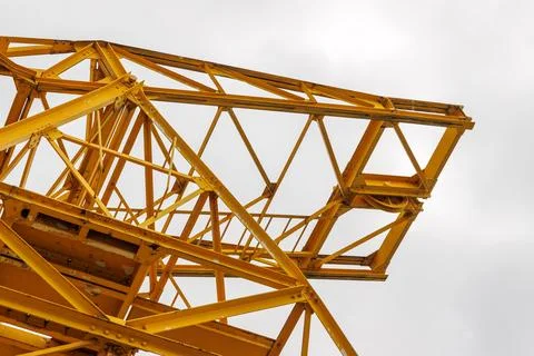 Low angle view of a yellow construction crane metal framework and lattice s.. Stock Photos