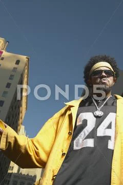 Low angle view of young African man standing in urban area Stock Photos