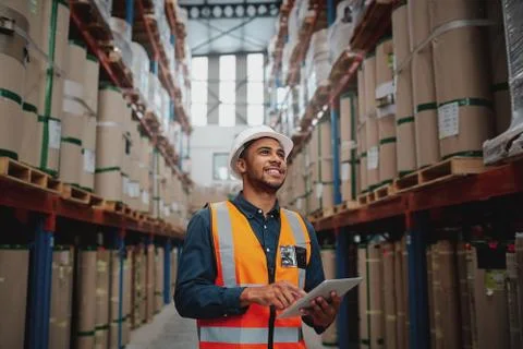 Low angle view of young african man wearing reflective jacket holding digital Stock Photos