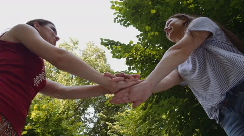 Low angle view of young attractive women cheering for victory Stock Footage 64794133