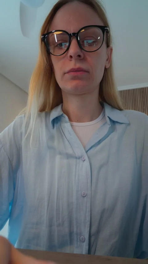 Low angle view of young blonde woman with glasses typing on laptop, showcas.. Stock Footage 327491939