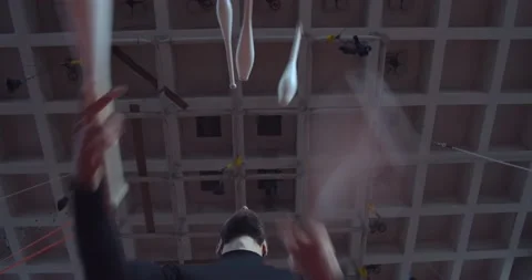 Low angle view on a young circus performer juggling maces, 4k Stock Footage 147191620