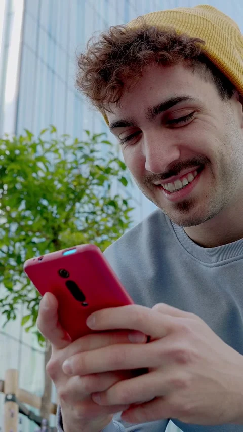 Low angle view of young college hipster student man using mobile phone outdoors Stock Footage 287134528