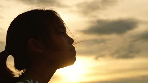 Low angle view of a young girl looking up at the sky Видео 337748460