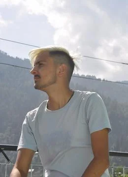 Low angle view of a young guy with dyed white hair looking sideways Stock Photos